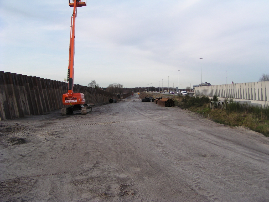 p2030027.jpg - Vanaf de Meerenakkerweg in de richting aansluiting Veldhoven Noord. Aan de zandafzetting op de geluidsschermen zien we duidelijk dat de damwanden oorspronkelijk tot bijna hun volledige lengte de grond werden ingetrild, en later weer omhoog zijn getrokken.