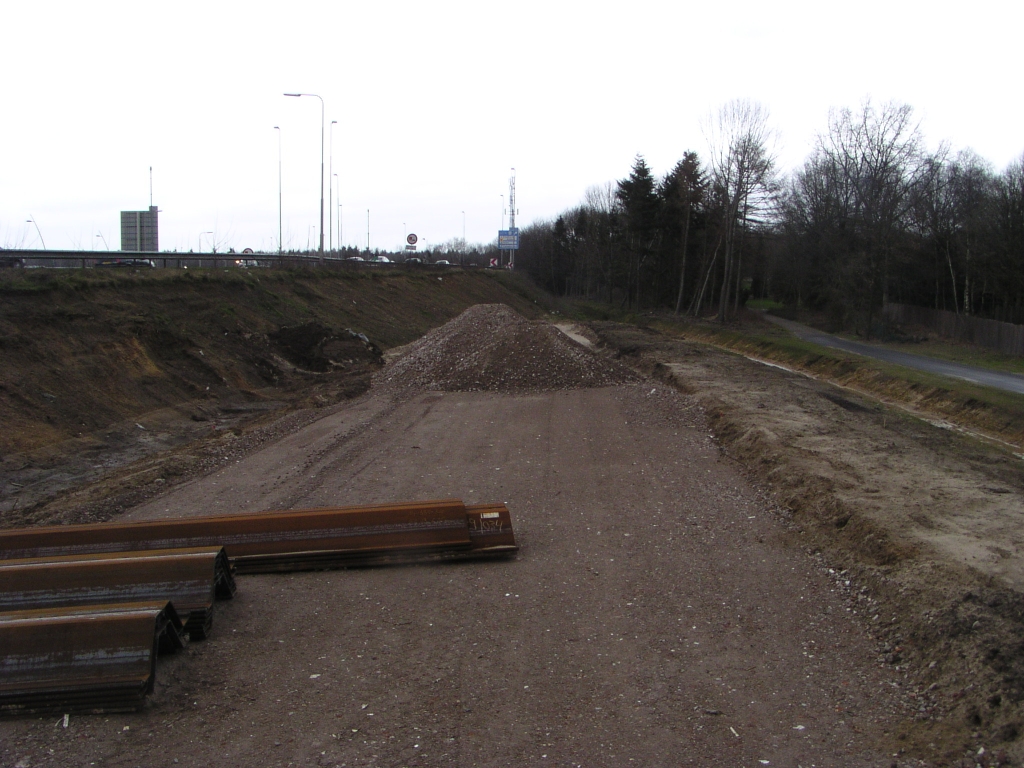 p3020028.jpg - De parallelbaan oost vanaf de Welschapsedijk tapert zich hier dicht tegen de oude hoofdrijbaan, die daar een slinger maakt in de aansluiting Strijp/Centrum en over de Tilburgsweg heen gaat. Pas als dat viaduct (KW C) en taluds zijn gesloopt kan hier de parallelbaan verder worden aangelegd.