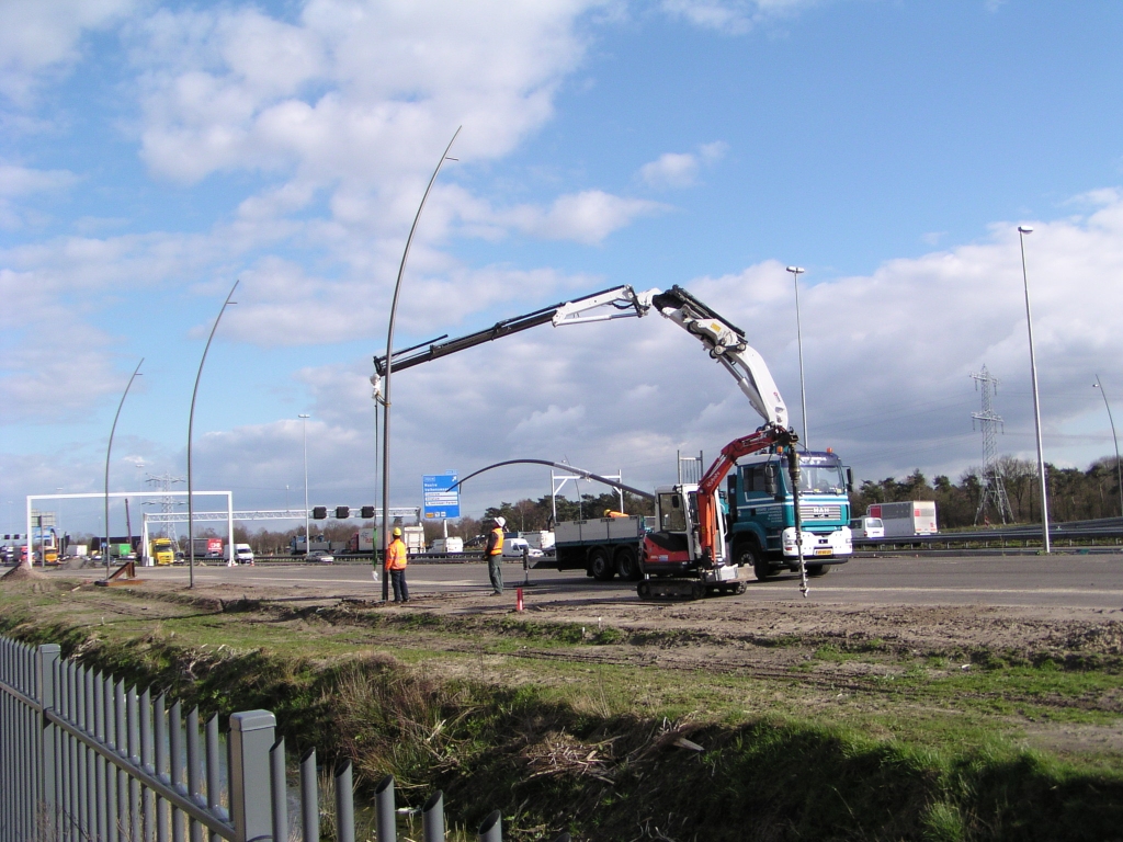 p3180002.jpg - Plaatsen van lichtmasten nabij de high tech campus. Rechts de gebruikte grondboor. Niet in beeld de vertrouwde waterpas waarmee de mast loodrecht wordt gesteld.