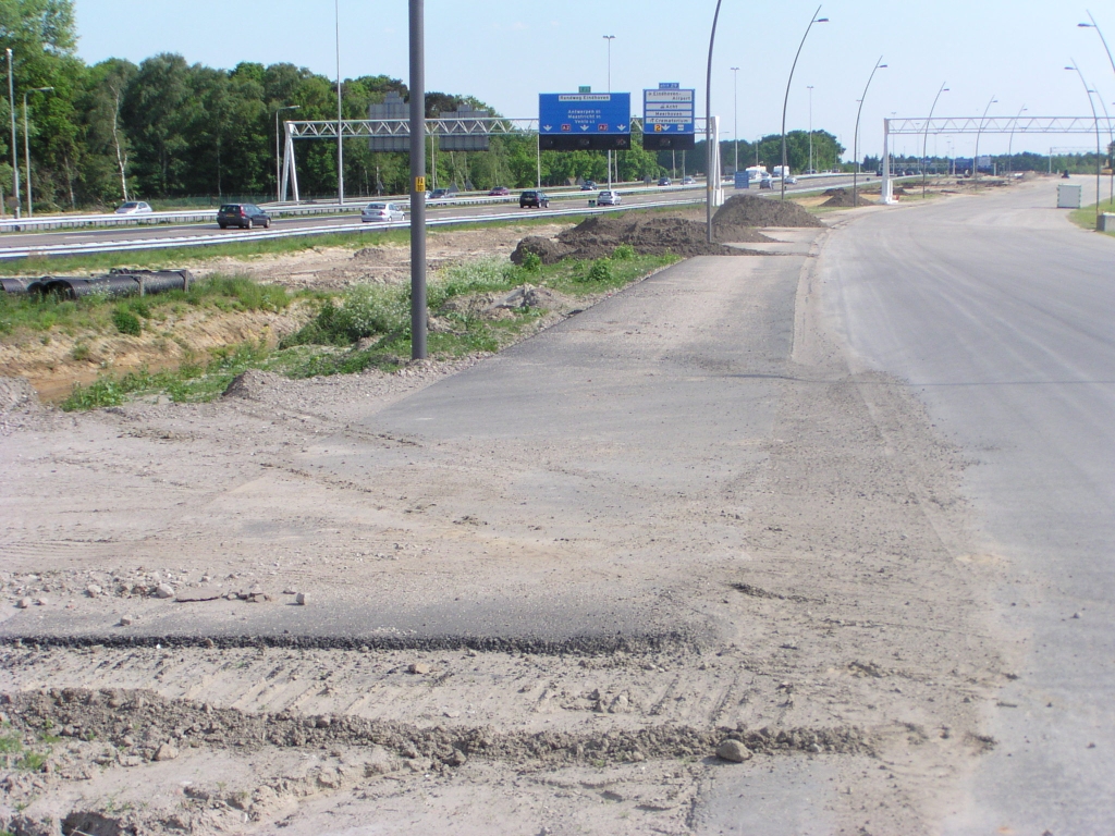 p5120082.jpg - Tussen KW 6 en KW 8 (Oirschotsedijk) is aan de reeds vier rijstroken brede parallelbaan nog een reep asfalt neergelegd. Werkverkeer in/uitvoeger?