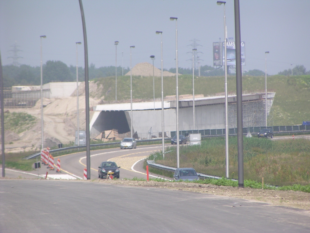 p6080009.jpg - Helft van KW 5 in kp. Batadorp met overspanning van de parallelbaan. Als het verkeer uit de richting Amsterdam op de voorgrond is omgezet naar die parallelbaan, kan de andere helft van het kunstwerk worden gebouwd, waar de hoofdrijbaan west onderdoor gaat komen. Vervolgens kan de nieuwe start van de A58 (denken we) in de richting Tilburg er overheen gelegd worden.  week 200813 