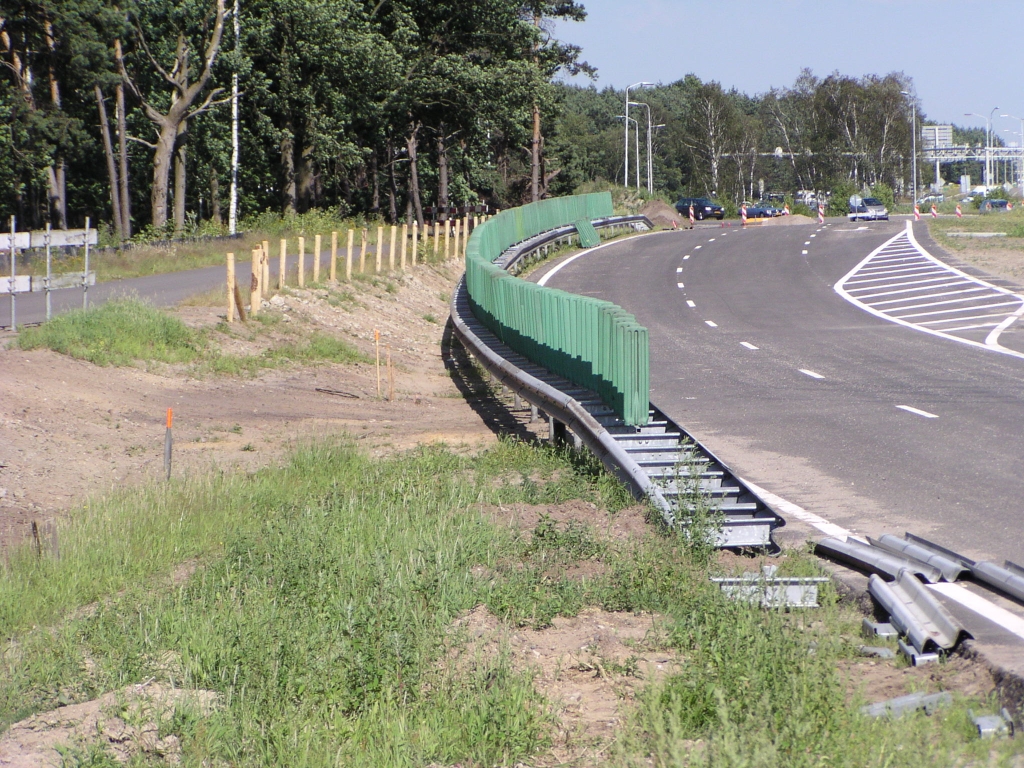 p6270047.jpg - Ter afscheiding van het vervaarlijk dicht bij de tijdelijke parallelbaan nabij kp. Leenderheide gelegen fietspad zijn een aantal maatregelen getroffen zoals houten paaltjes met ijzerdraad ertussen, geleiderails en antiverblindings opzetstukken. Als de parallelbaan op zijn definitieve plek ligt, verder naar rechts, komt er een bermsloot.