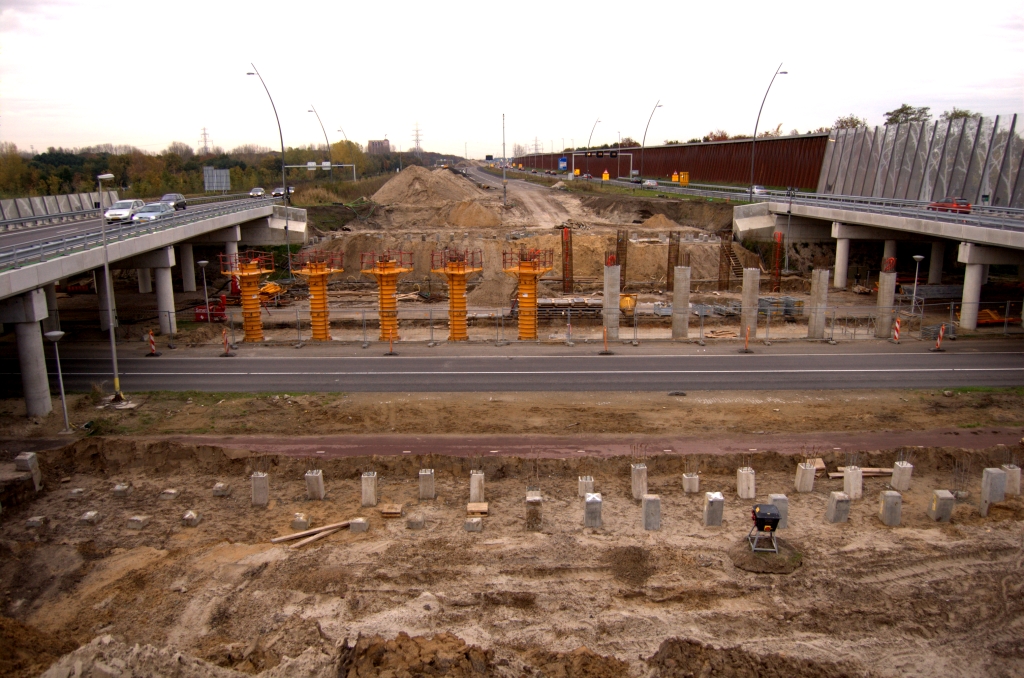 20081102-170354.jpg - Toestand KW 28 (prof. Holstlaan). Het aantal pilaren voor de hoofdrijbanen is gelijk aan dat van de parallelbanen, en ze staan zo te zien niet verder uit elkaar. Het lijkt er dus op dat de hoofdrijbaanviaducten ongeveer even breed worden als de parallelbaan exemplaren. Toch lezen we in het tracebesluit een breedte van 18,85 meter voor de hoofdrijbaanviaducten tegen 15,45 en 16,80 meter voor de parallelbaan.  week 200840 