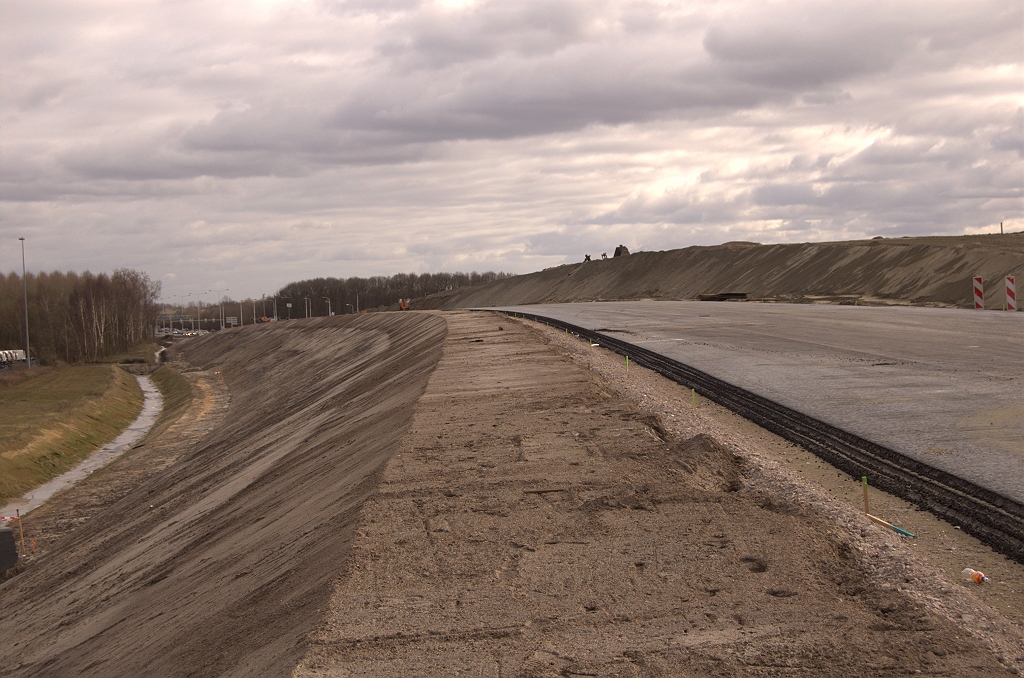 20090315-152210.jpg - Het kolossale grondbouwwerk aan de oostzijde. Het bedrijventerrein Ekkersrijt was al in tweeen gedeeld door de A50, maar met deze barriere wordt de kloof tussen het oudere gedeelte aan de oostzijde en het nieuwere alleen nog maar groter.