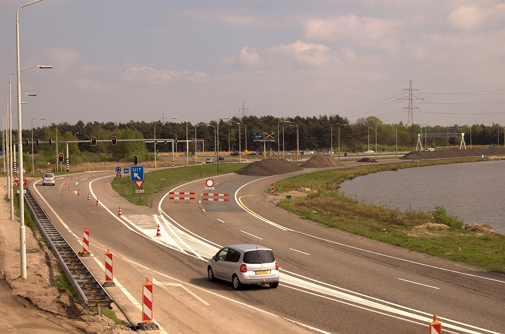 20090419-151528.jpg - ...zodat de rotonde Leenderheide bereikbaar blijft. De afgesloten bypass is in gebruik als opslagruimte voor asfaltschraapsel, zodat we sterk het vermoeden krijgen dat hij niet meer open zal gaan. We weten niet precies wanneer de bypass is aangelegd. Op een  luchtfoto op watwaswaar.nl  uit 1992 is-ie er nog niet.