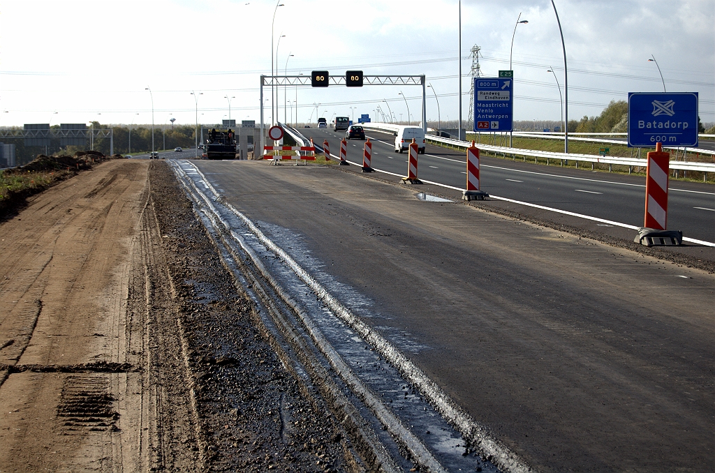 20091025-132409.bmp - Splitsing hoofd- en parallelrijbaan in kp. Ekkersweijer. Bij de openstelling van dit stukje N2, zeven maanden geleden, werd al een strook asfalt voor de A2 aangelegd met typische terrasvorm zodat er nog een strook aan "vastgeplakt" kan worden. Daar lijkt de tijd nu rijp voor.  week 200915 