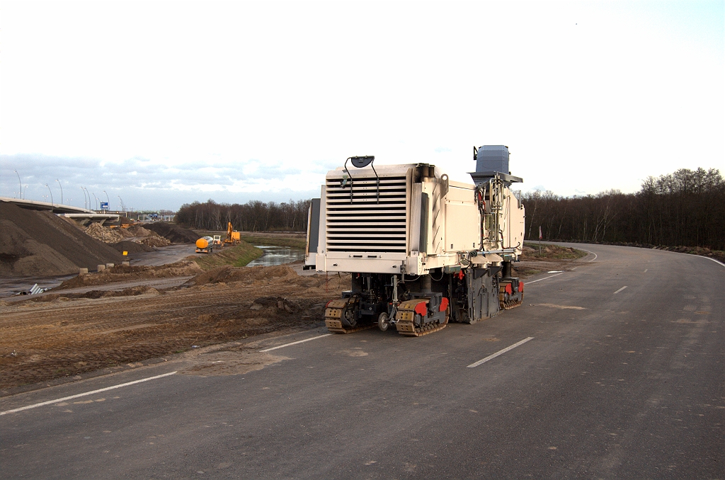 20091122-172227.bmp - Verlaten A67 bypass. De beul is deze keer niet van de firma Freesmij. Als het sloopwerk gereed is kan de herinrichting van het Dommelgebied beginnen. Dat gebied strekt zich uit van KW 25 (kleine brug links) tot aan de bosrand rechts. Er moet ook een fietspad komen dat onder de zeven Dommelbruggen doorloopt.