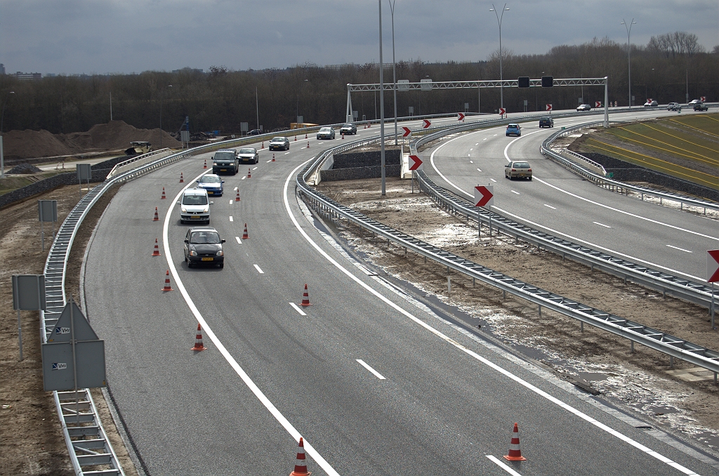 20100321-155005.bmp - Verder verloop van de A50 rijbaan in de richting Nijmegen, tegen de rijrichting in. Met de markering aangebracht valt op dat er op KW 42 nauwelijks ruimte is opengelaten tussen de linkerkantlijn en de geleiderail. Een doorlopende zichtlijn werd hier dus niet noodzakelijk geacht in de linkse bocht.  week 201009 