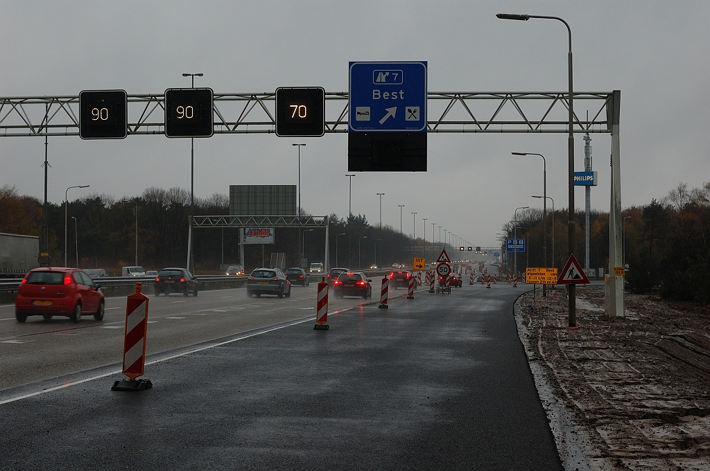 20101114-125333.JPG - Gehele wegvakje tussen het viaduct en de afrit is voorzien van ZOAB, wellicht als resultaat van de nachtelijke afsluitingen deze week. In het laatste aflsuitweekend (20-21 november 2010) hoeft dus nog enkel de markering te worden gewijzigd. In de verte een nieuw mastbord dat de verzorgingsplaats Kriekampen aankondigd (sorry, geen detailfoto).  week 201043 