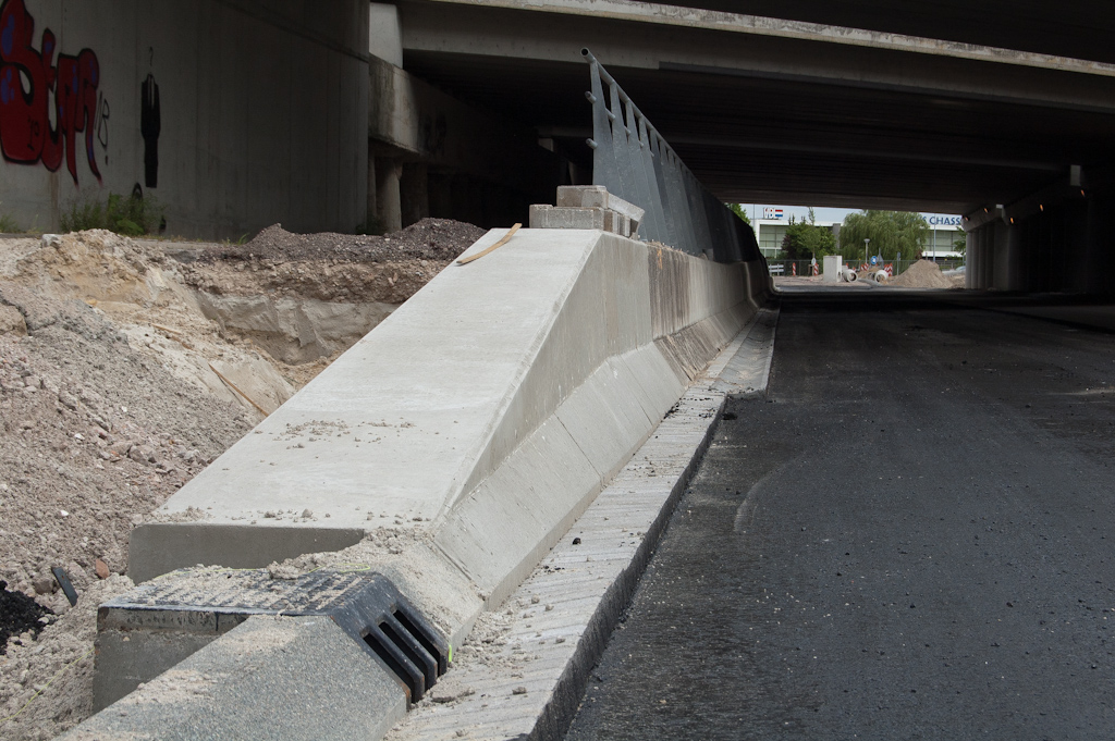 20110522-143010.jpg - Ook de betonmannen hebben er een handje van om in 1 week tijd hun klus volledig af te ronden. Vloeiende overgang gerealiseerd tussen opsluitband en grondkering onder het viaduct. Tussen de gootconstructies is het resultaat wat hoekiger geworden.  week 201119 