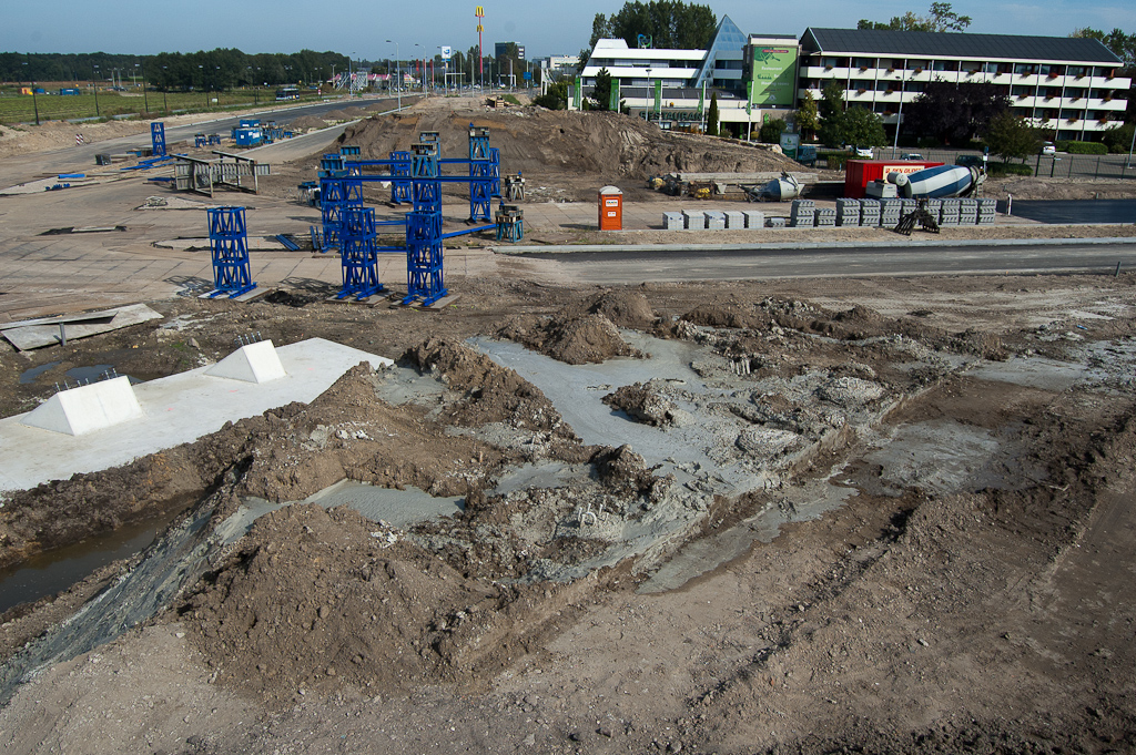 20110924-120540.jpg - De wapeningscylinders die vorige week nog gereed lagen op de Hovenring kruising zijn verdwenen. Op het zuidelijk fietspadtalud zien we plassen van cementachtig spul...