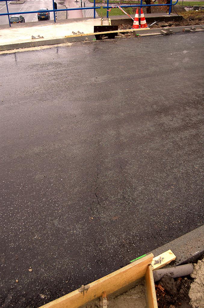 20081130-132157.jpg - In de zuidelijke rijbaan is heel die spleet onzichtbaar door een volgende laag asfalt. Er is ook een scheurtje zichtbaar. Misschien dat er later weer een reepje wordt uitgefreesd zodat er een echte (?) voegovergang kan worden aangelegd.